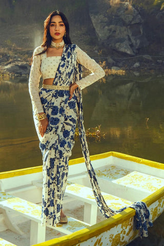 Pre-draped stitched saree with indigo bird print paired with off-white embroidered blouse and diamond butti belt, offering statement elegance for wedding receptions and evening functions.
