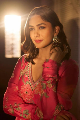 Luxury blooming pink Anarkali in signature floral print Mrunal Thakur ethnic look with antique sequin, mirror, and resham detailing, paired with a hand-embroidered net dupatta for a regal finish. Designed by Paulmi and Harsh.