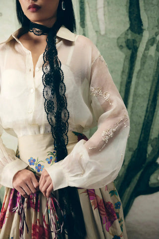Close view of the Alora off white skirt set highlighting delicate organza embroidery, front-open shirt styling, and buttoned cuffs for a polished modern designer fashion statement.