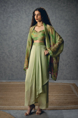 Elegant Cleo green floral skirt set pairs a lightweight organza jacket with a pleated blouse and wrap skirt, making it a graceful choice for festive parties and celebrations.