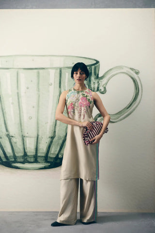 Ivory Shiro kurta pant set crafted in luxurious Chiniya silk, featuring a relaxed-fit tunic with floral embroidered yoke and striped pants, ideal for festive celebrations and weddings.
