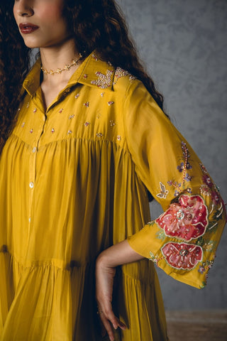 Close-up of the Yellow Lana Dress highlighting its delicately embroidered collar and yoke, complemented by artistic printed sleeves for a sophisticated designer look at evening and festive events.