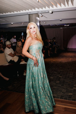 fashion show in Sydney by Australian Fashion Grandeur. Model in blue silver jacquard fusion jumpsuit dress ideal for cocktail parties, wedding reception or night outs.
