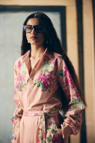 Detailed close-up of delicate placement print on soft pink poplin fabric with refined stitching details.