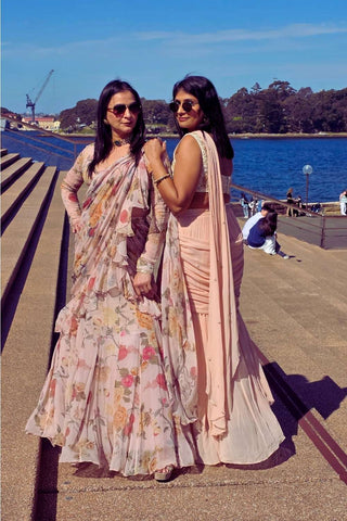 Elegant vintage-style pre-draped chiffon saree featuring soft floral prints and intricate hand-embroidered lace pared with full sleeve blouse.