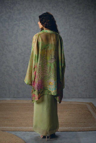 Back look of Cleo women's green designer skirt set features a relaxed floral jacket and wrap-around skirt fitted at the waist, creating a flattering silhouette for sophisticated occasion dressing.