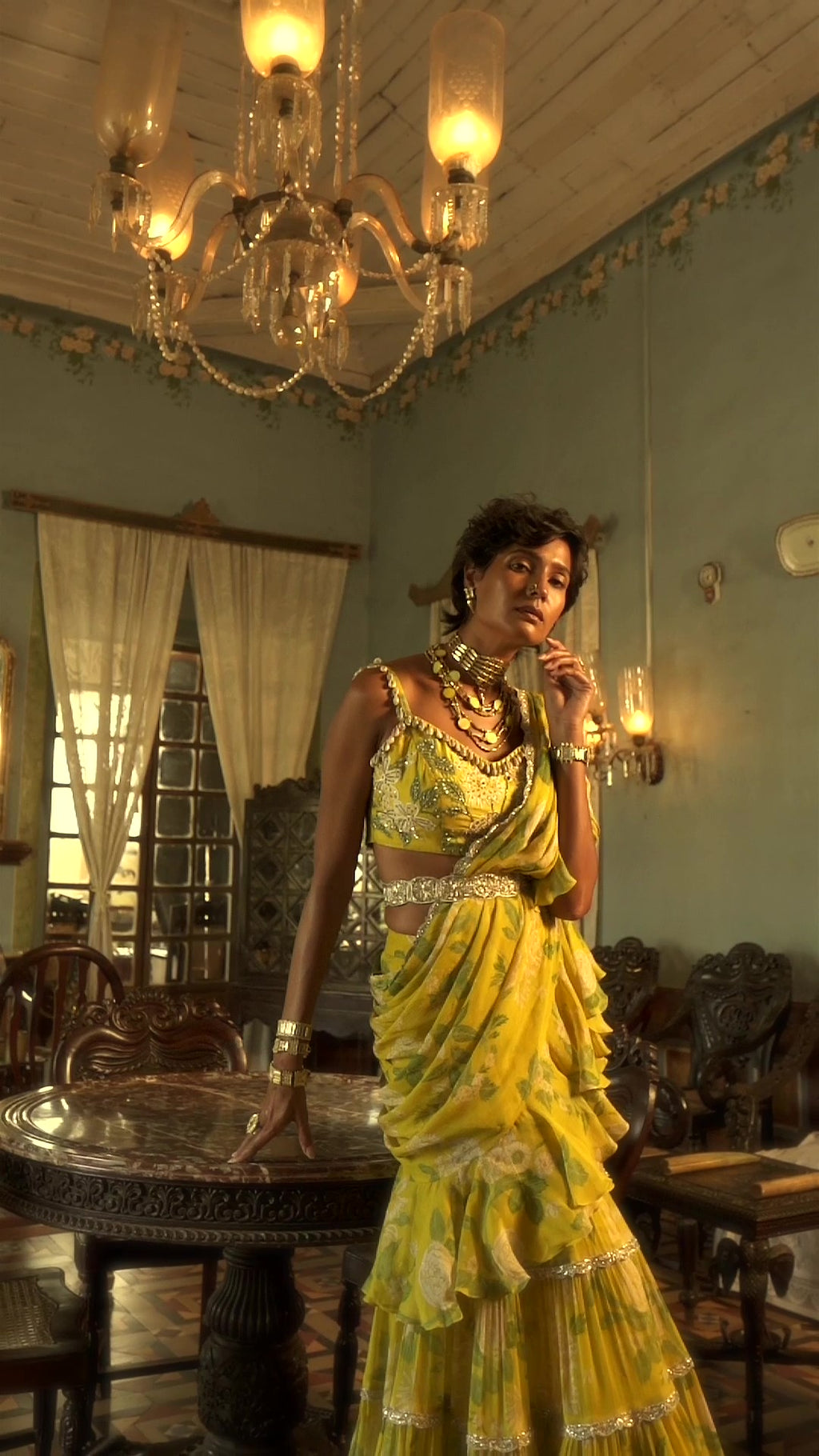 Model in lime yellow self–woven russian jacquard lehenga set paired with antique silver zari jaal embroidered blouse and pure tissue dupatta. Easy to wear pre-draped saree designed by Paulmi and Harsh.