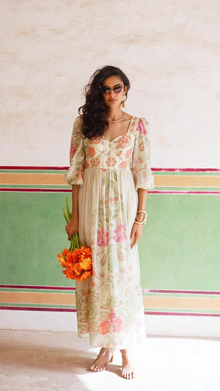 Model in ivory floral maxi dress in soft silk organza, with a statement cutwork embroidery. All-rounder dress for Resort Ready, Maxi Moments, brunch to soiree, vacation in style, gen-z glam, floaty and fierce and more. Designed by Paulmi and Harsh.