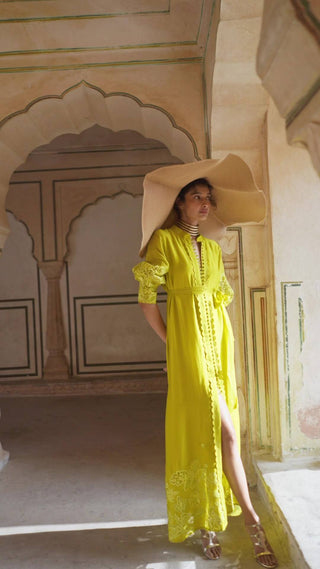 Model in fresh lime yellow cutwork long sleeves maxi dress with belt and center slit designed by Paulmi and Harsh. An indo-western chic women's dress for casual outing or parties, summer, vacation, events, special occasions.
