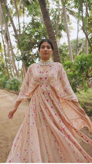 Model in gorgeous rose border print kaftan highlighted with moti, mirror and cutdana is an easy pick for a beach, outings, evening events, cultural outfit for women. Designed by Paulmi and Harsh.