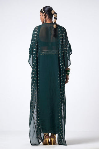 Back look of bottle green Forest Karl Green Choga set in crepe fabric with hand embroidery, scattered sequins, skirt, bralette, and statement cape.