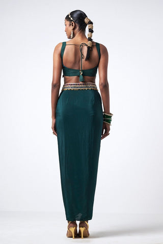 Back look of bottle green embroidered cape set with flowing crepe skirt and delicate scattered sequin accents for festive occasion wear.