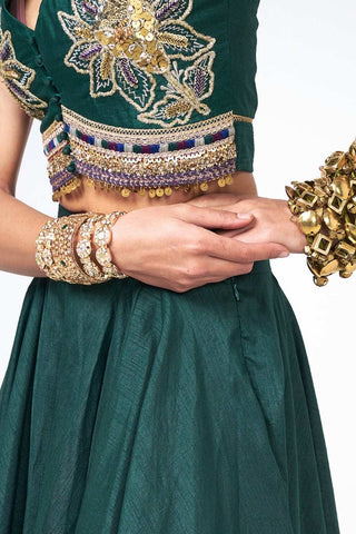 Close up of bottle green Dupion Jalsa Lehenga Set by Rishi and Vibhuti showcasing handcrafted embroidery with scattered sequins on crop top with a matching skirt, this luxurious designer ensemble is perfect for festive occasions, wedding functions, and celebration wear.