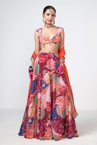 Cherry and orange lehenga set featuring embroidered blouse detailing, flowing skirt silhouette, and coordinated dupatta styled for weddings, festive occasions, cocktail celebrations and destination wedding ceremonies.