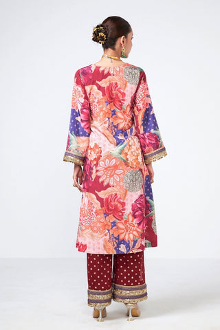 Back look of cherry choga set in cola-colored crepe and georgette featuring intricate appliqué work with scattered curve detailing, coin embellishments, and tassels. This elegant kurta and pants set is ideal for festive celebrations, parties, weddings, and cultural occasions.