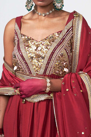 Detailed close-up of subtle hand embroidery on luxurious cherry Chanderi fabric with elegant artisanal finishing.