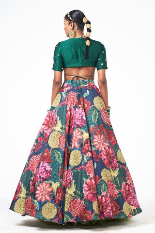 Back look of emerald green festive lehenga highlighting elegant silhouette and refined handwork accents.
