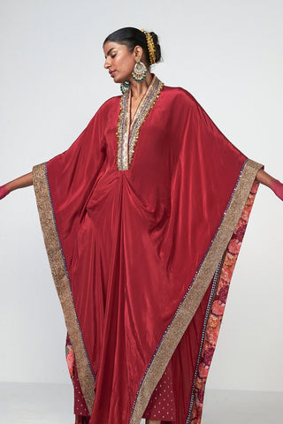 Cherry kaftan set in crepe fabric featuring subtle hand embroidery, crystal hanging details, and coordinated pants for elegant festive wear.