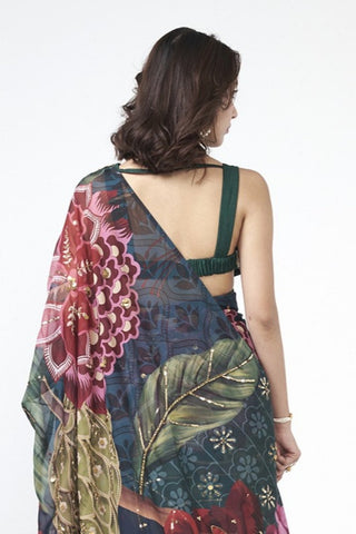 Back look of emerald green saree ensemble highlighting graceful silhouette and refined hand embroidery accents.