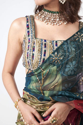 Detailed close-up of applique trims and delicate handcrafted embellishments on bluse andluxurious organza fabric saree.
