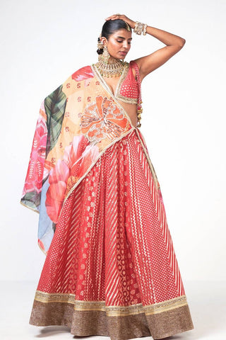 Designer Gulbahar coral lehenga set crafted from premium Chanderi and organza with intricate appliqué detailing. Featuring a coordinated lehenga, blouse, and dupatta, this luxurious outfit is perfect for festive events, wedding functions, and celebration wear.