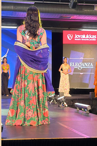 Back look of jade green festive lehenga highlighting elegant silhouette -model posing in fashion show runway in Australia 