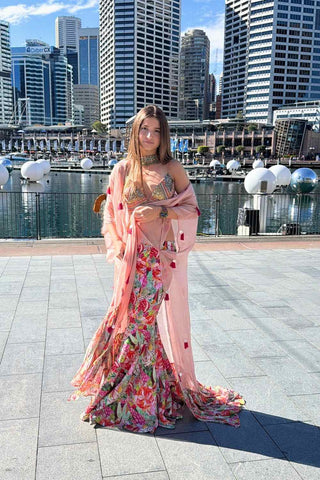 Elegant crepe and organza lehenga set showcasing intricate threadwork, tassel details, and contemporary festive glamour.