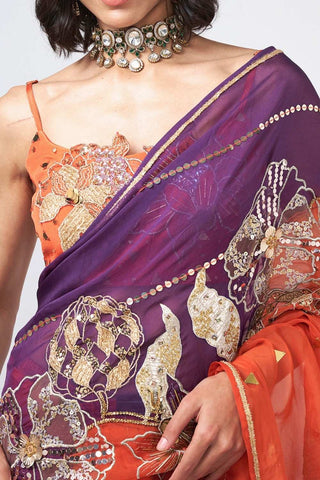 Detailed close-up of applique handwork and patchwork craftsmanship on saree organza and crepe fabric.