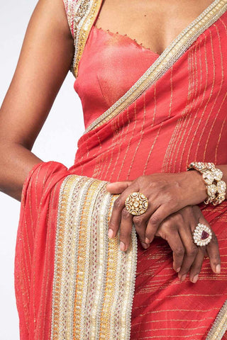 Close up of Red Chandini saree by Rishi and Vibhuti featuring luxurious georgette and Chanderi silk fabric with refined linear embroidered detailing, offering an elegant designer ethnic look for wedding guests, festive events, and celebrations.