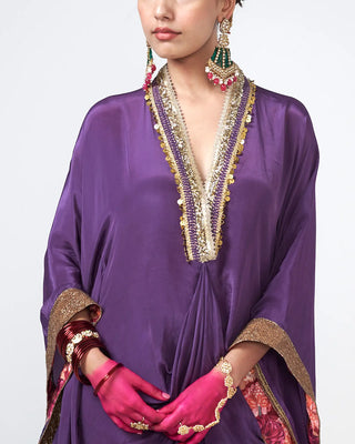 Close-up of hand-applied applique work on the crepe kaftan fabric.