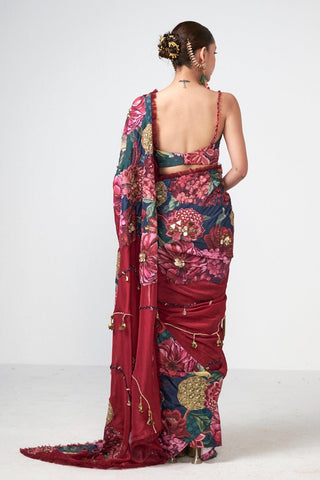 Elegant floral printed saree featuring subtle handcrafted embroidery, golden bead detailing, and romantic tulle lace accents for a sophisticated festive look.