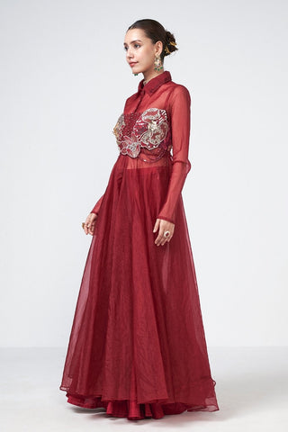Contemporary cherry three-piece coord set with sheer cape, structured corset in net and crepe, and intricate handcrafted embroidery.