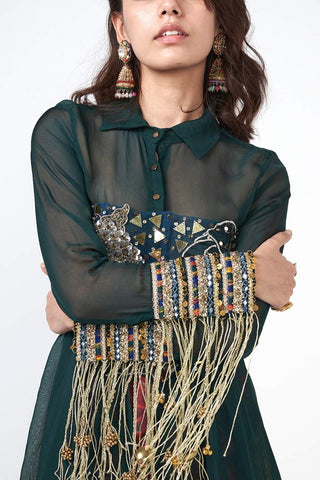 Elegant festive outfit with statement jacket, embroidered corset, and tailored pants accented with scattered sequins.
