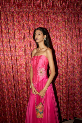 Contemporary fusion outfit in fuchsia crepe with structured corset bodice and voluminous fit-and-flare skirt.