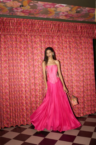 Statement fuchsia pink crepe coord set by Rishi and Vibhuti with embellished corset and flared skirt silhouette.