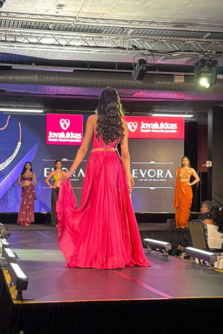 Back look of pink crepe corset lehenga set with handcrafted patchwork detailing and fit-and-flare silhouette at fashion show in sydney.