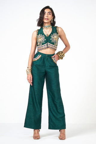 Dusk Doom Emerald two-piece Dupion coord set in bottle green featuring a stylish crop jacket and LL pants. Enhanced with hand embroidery and shimmering scattered sequins, this designer outfit offers contemporary festive elegance.