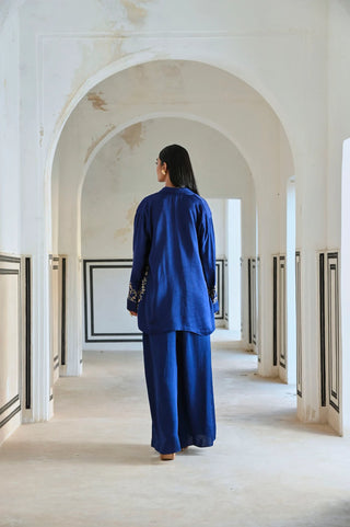 Back look of Royal blue embroidered blazer paired with a bralet and palazzo, offering a modern coordinated ensemble for women’s festive dressing and special occasions.