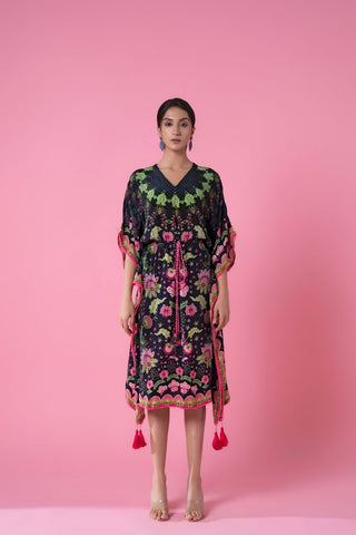 A breezy midnight black ombre floral print kaftan perfect for resort wear, featuring lightweight fabric, soft embroidery, and pom-pom lace trimming. The free-flowing design adds comfort and elegance for seaside evenings.