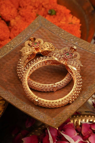 Designer temple bangles with antique gold plating and jadau detailing, secure screw fastening ensures comfort, suitable for weddings and special occasions.