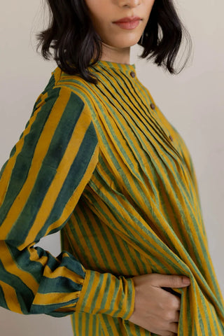Close-up of block printed green stripe balloon sleeve with cuff and pintucked front